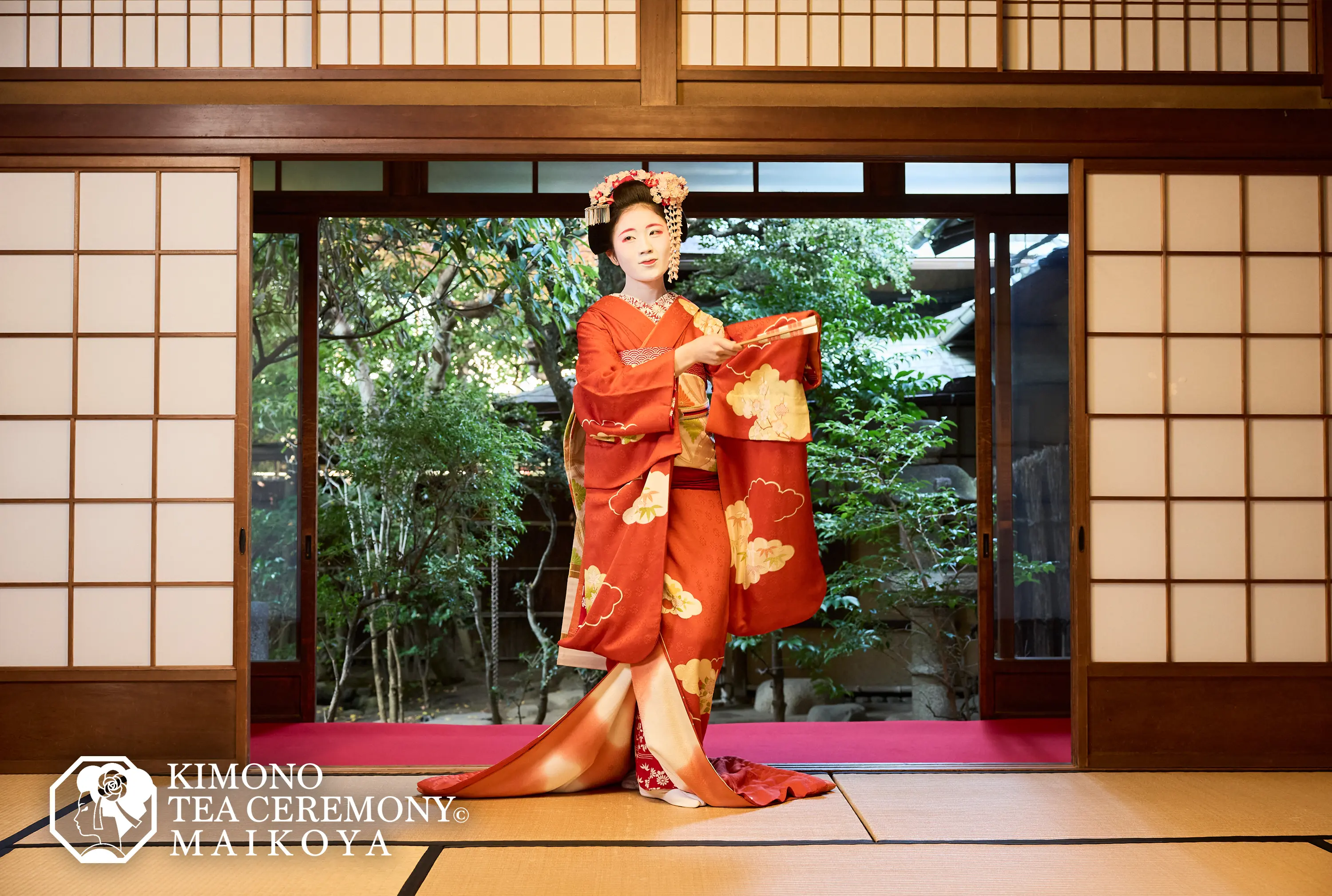 Maiko performing a traditional dance in a historic Kyoto teahouse