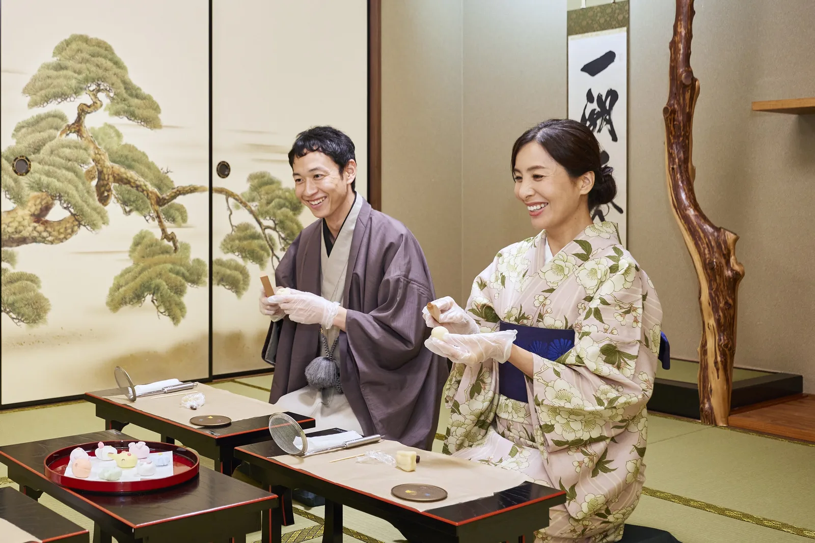 Hosts presenting handmade seasonal wagashi in Kyoto