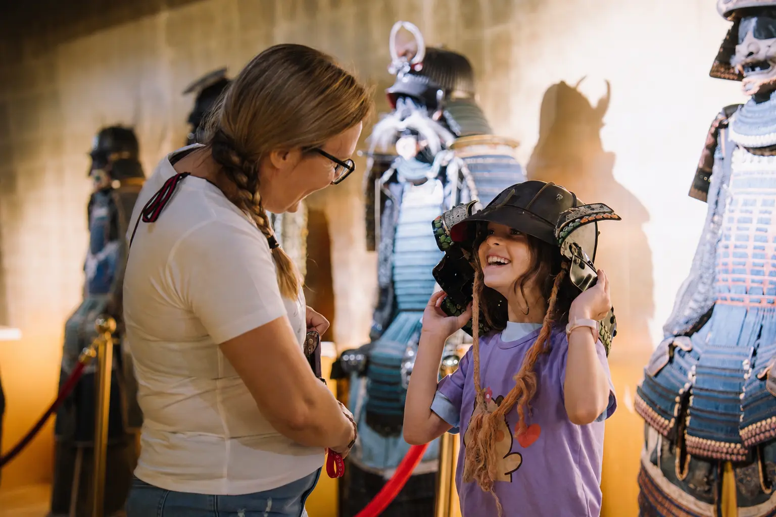 A child delighted by a samurai helmet