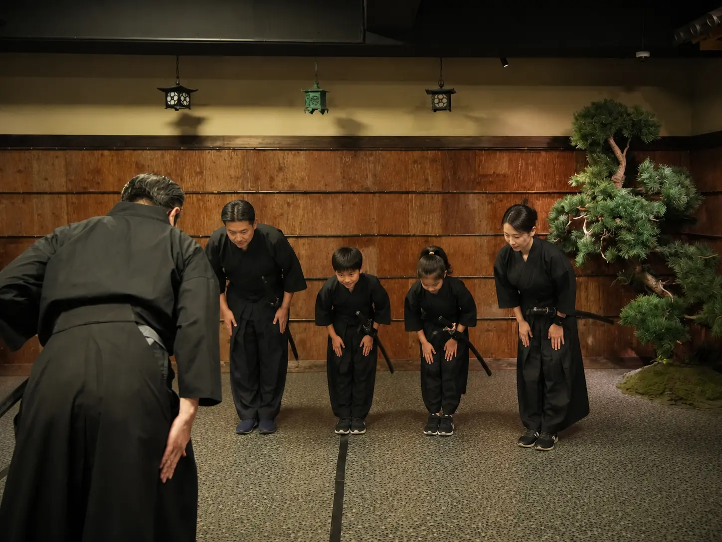 A samurai family beginning their lesson with a respectful bow